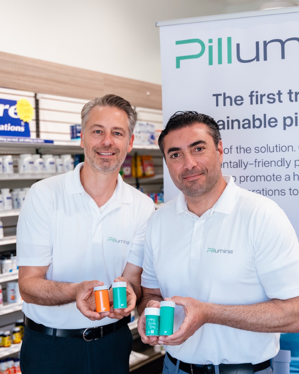 Pillumina co-founders Peter Daheb and Abe Matar holding aluminum pill bottles in a pharmacy