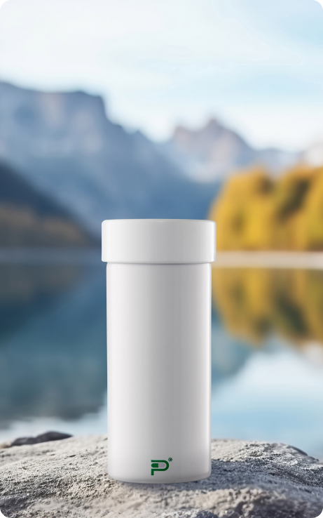 A Pillumina aluminum pill bottle on a rock beside a mountain lake
