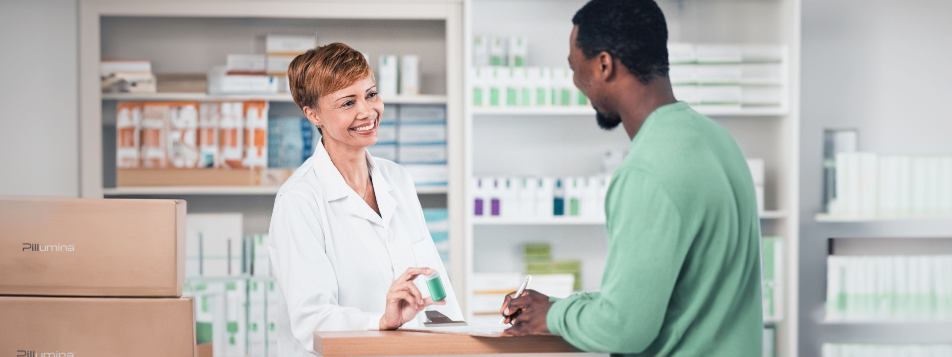 A pharmacist handing a Pillumina bottle to a customer over the counter